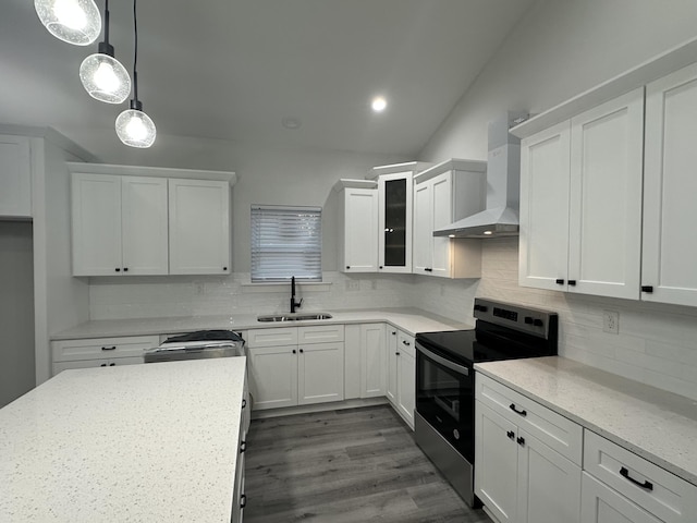 kitchen with black range with electric stovetop, white cabinetry, and wall chimney exhaust hood