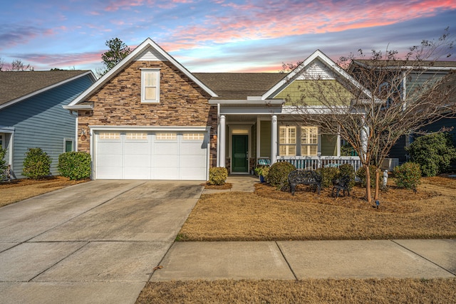 view of front of property with a porch and a garage