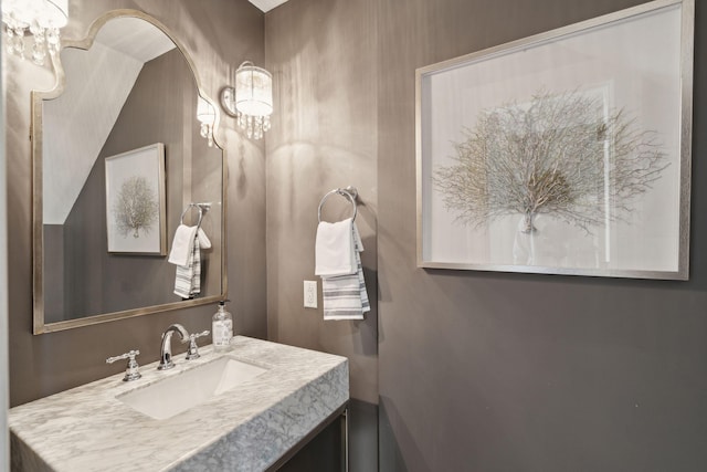 bathroom featuring vanity and a chandelier