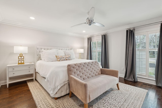 bedroom with multiple windows, crown molding, baseboards, and wood finished floors