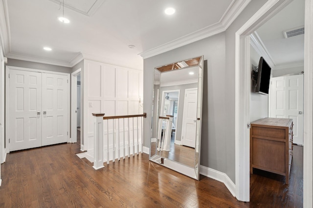 hallway featuring visible vents, an upstairs landing, ornamental molding, attic access, and dark wood-style flooring