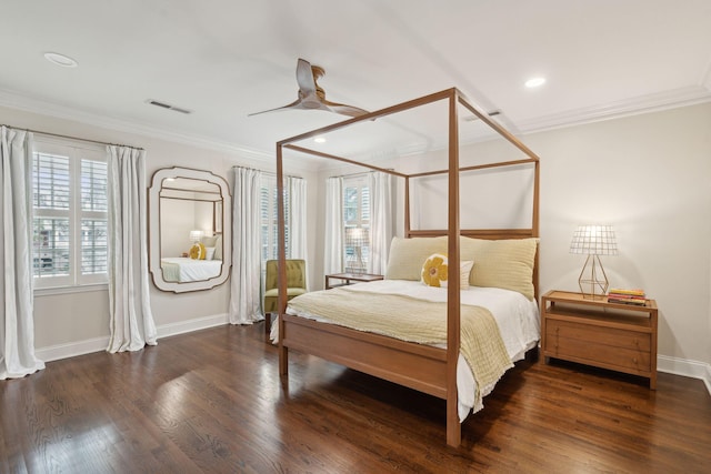 bedroom featuring visible vents, multiple windows, and wood finished floors