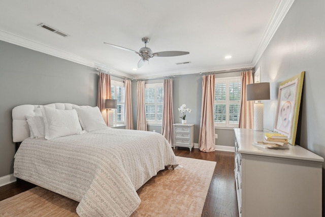 bedroom with dark wood-type flooring, baseboards, visible vents, and ornamental molding