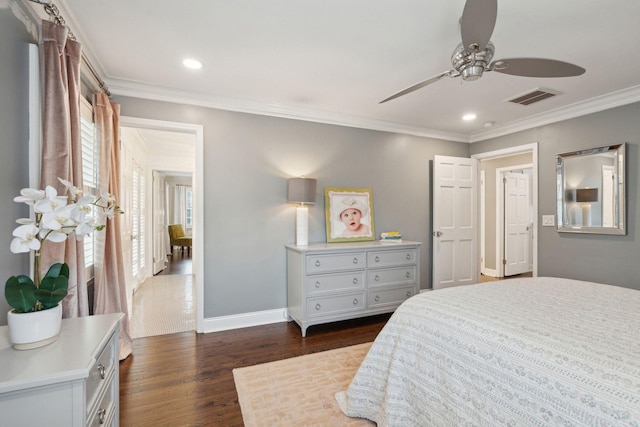 bedroom with visible vents, crown molding, dark wood-type flooring, baseboards, and recessed lighting