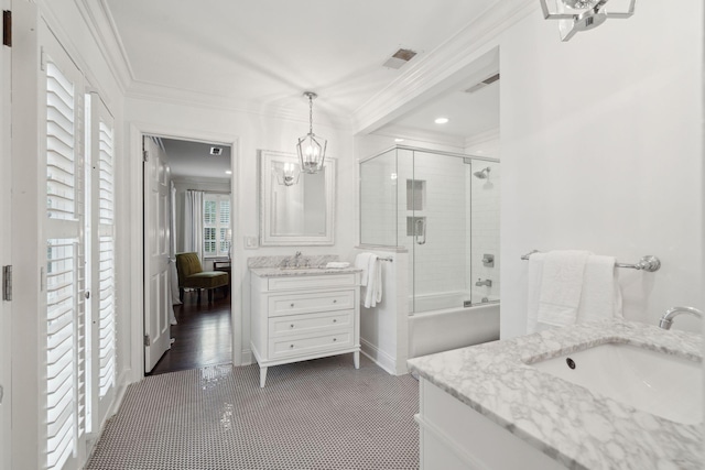 bathroom with visible vents, vanity, crown molding, and shower / bath combination with glass door