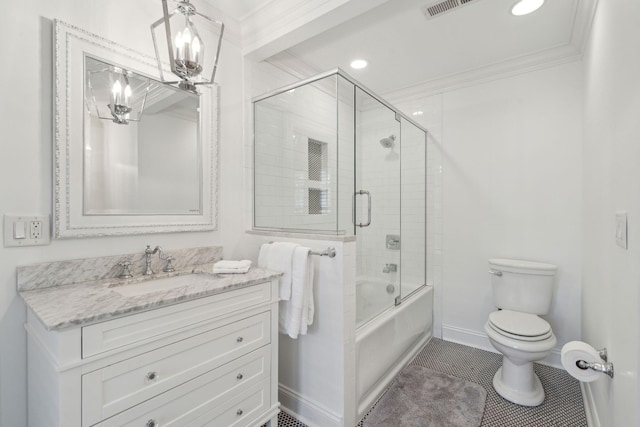 full bath with vanity, baseboards, shower / bath combination with glass door, crown molding, and toilet