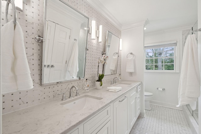 bathroom with a sink, baseboards, toilet, and crown molding