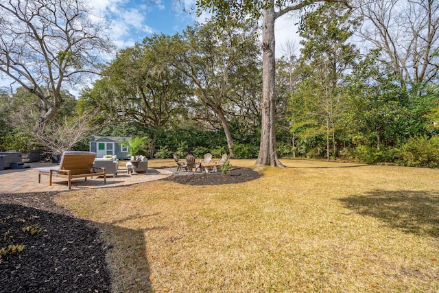 view of yard featuring an outdoor structure and a patio area