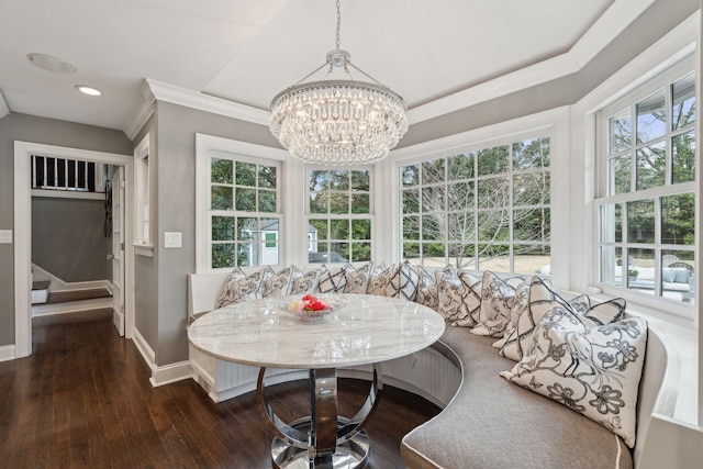 dining room with breakfast area, a wealth of natural light, and wood finished floors