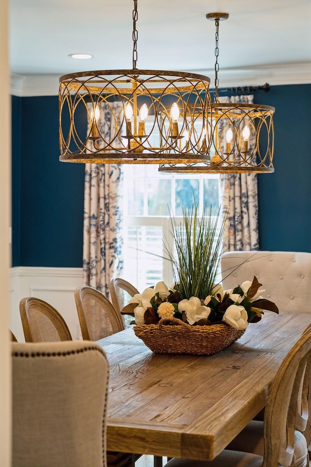 dining room with a wainscoted wall and ornamental molding