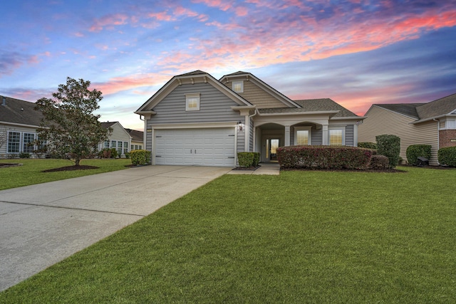 view of front of property with driveway, a garage, and a yard