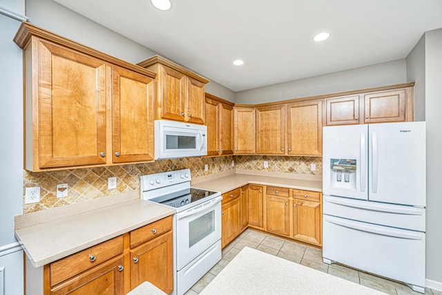 kitchen featuring white appliances, decorative backsplash, light countertops, and recessed lighting