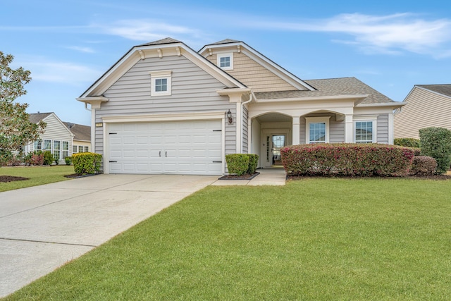 view of front facade with driveway, a shingled roof, a garage, and a front lawn