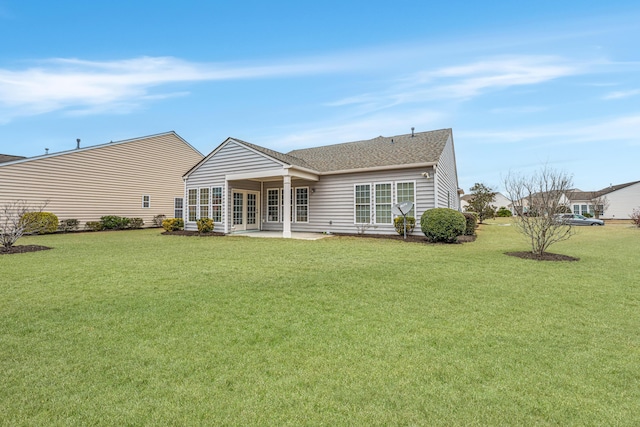 back of house with french doors, roof with shingles, a yard, and a patio