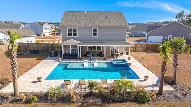 back of house with a pool with hot tub, an outdoor living space, and a patio