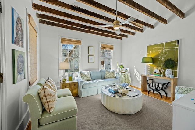 living room featuring ceiling fan and beamed ceiling