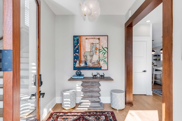 hall featuring wood finished floors and baseboards