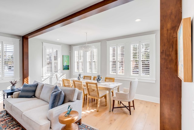 living area with recessed lighting, light wood-style floors, a chandelier, beamed ceiling, and baseboards