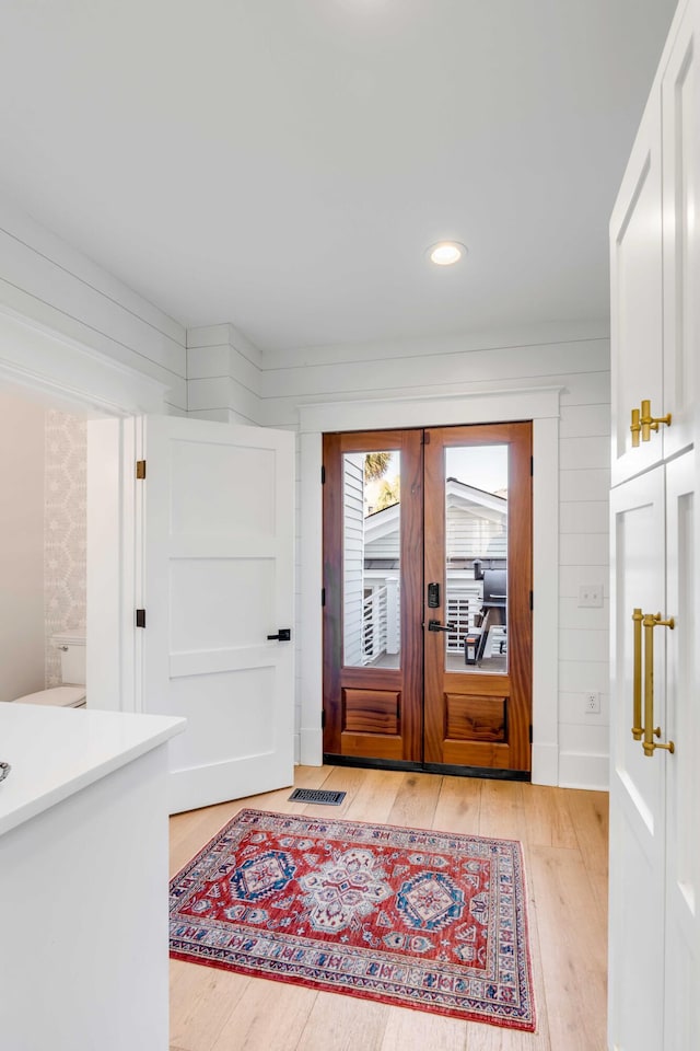 foyer entrance featuring visible vents, french doors, light wood-style flooring, and recessed lighting