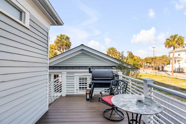 wooden deck with a grill