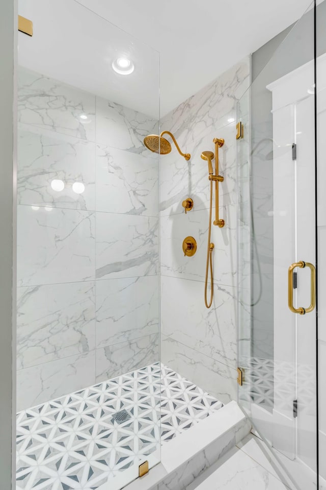 bathroom featuring marble finish floor and a marble finish shower