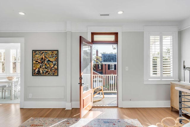 entryway featuring recessed lighting, wood finished floors, visible vents, and baseboards