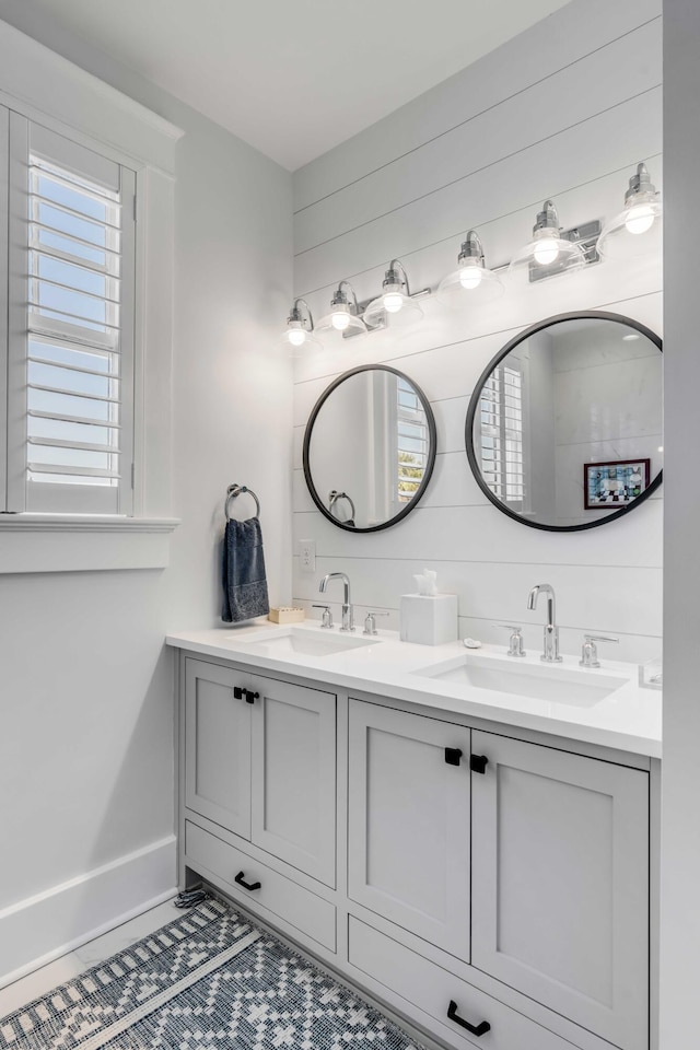 bathroom featuring double vanity, tile patterned flooring, and a sink