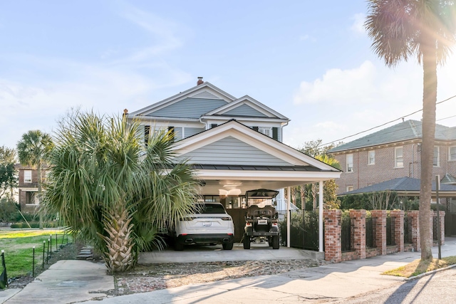 view of home's community featuring driveway and fence