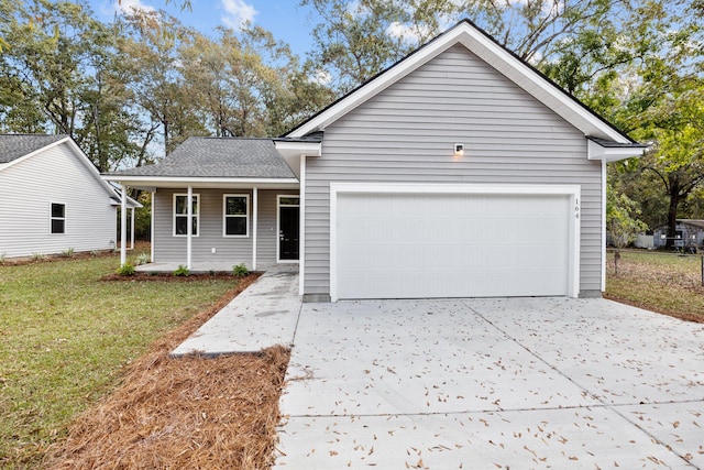 view of front of house with a front lawn and a garage