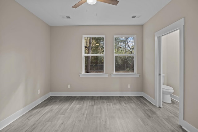 unfurnished bedroom featuring ceiling fan, light hardwood / wood-style floors, and ensuite bath