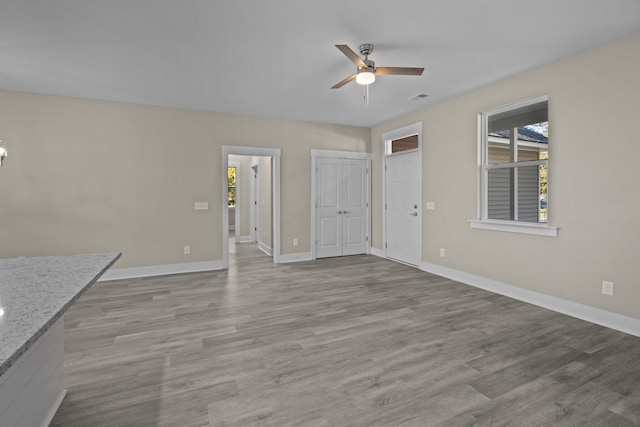 unfurnished living room featuring light hardwood / wood-style floors and ceiling fan