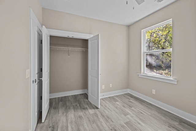 unfurnished bedroom with a closet, ceiling fan, and light hardwood / wood-style flooring