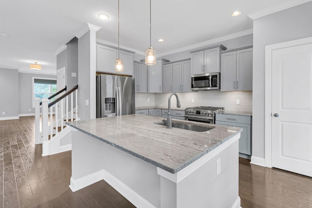 kitchen featuring appliances with stainless steel finishes, light stone countertops, sink, and dark hardwood / wood-style flooring