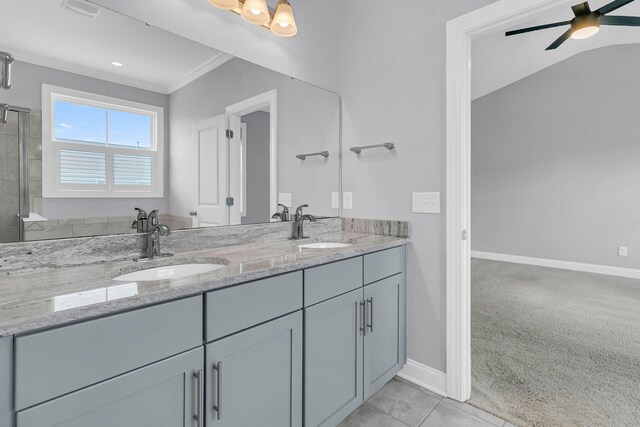 bathroom with ceiling fan, walk in shower, vanity, ornamental molding, and tile patterned flooring