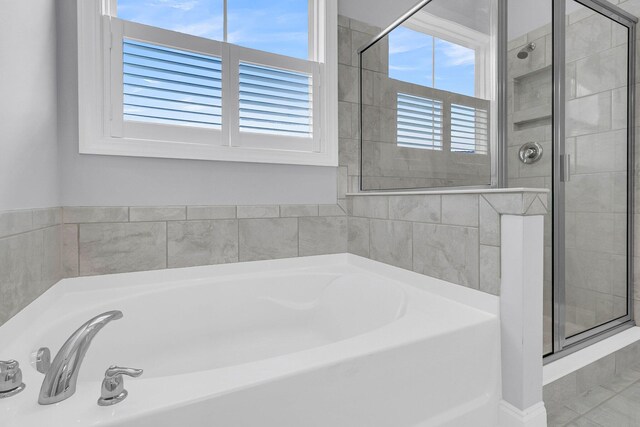 bathroom with separate shower and tub