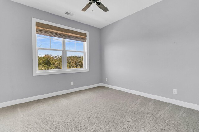 spare room with carpet and ceiling fan