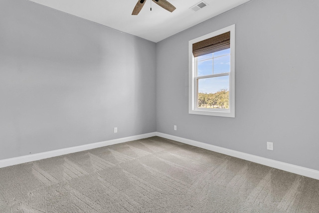 spare room featuring carpet and ceiling fan