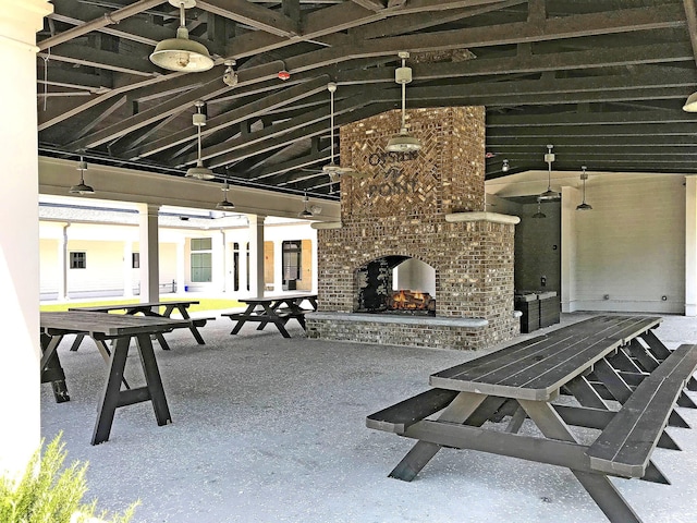 view of patio with an outdoor brick fireplace