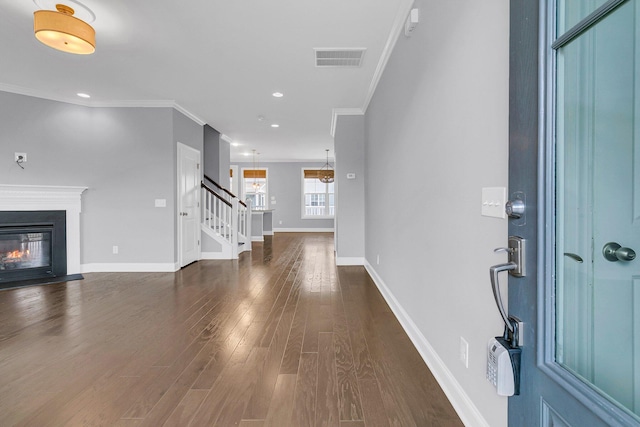 foyer featuring ornamental molding and dark wood-type flooring