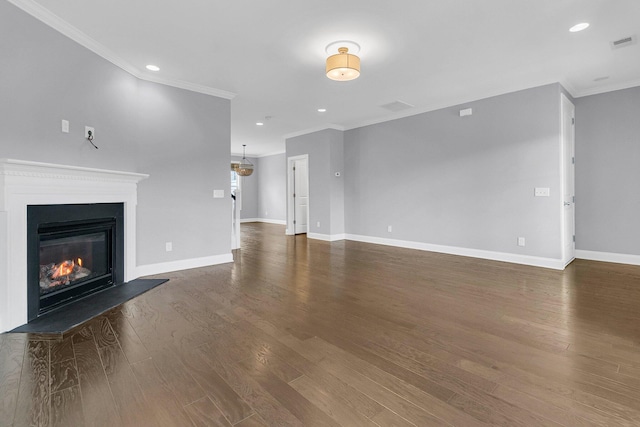 unfurnished living room with crown molding and dark hardwood / wood-style flooring