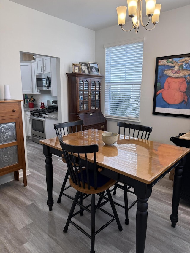 dining area featuring a chandelier and light wood-type flooring