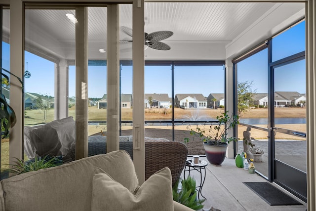 sunroom / solarium featuring ceiling fan