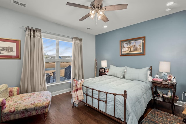 bedroom with ceiling fan and dark wood-type flooring