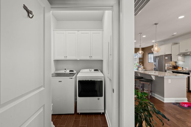 laundry area featuring cabinets and washer and clothes dryer