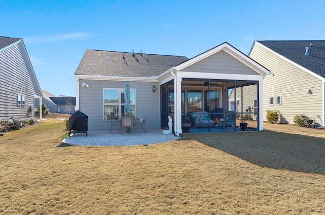 rear view of house featuring a yard and a patio area