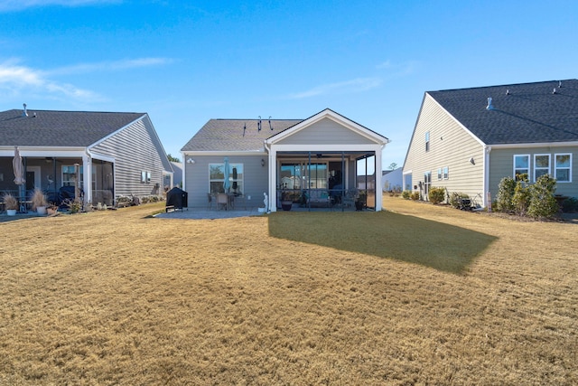 back of house featuring a patio area and a yard