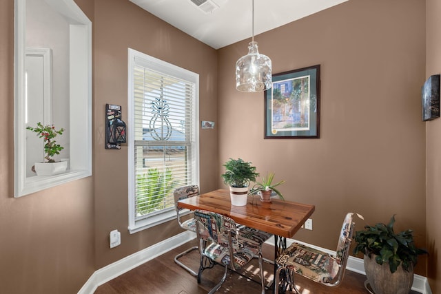 dining space with dark hardwood / wood-style flooring and a wealth of natural light