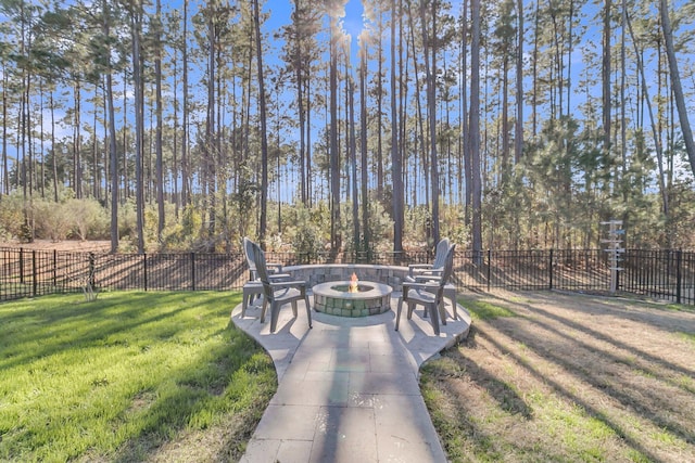 view of home's community featuring a yard, a patio area, and an outdoor fire pit