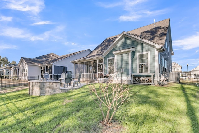 back of property featuring a lawn, a sunroom, and a patio area