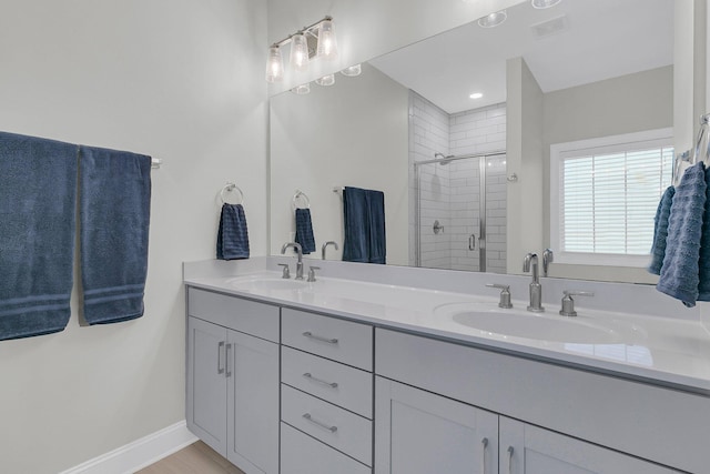 bathroom featuring vanity and a shower with door